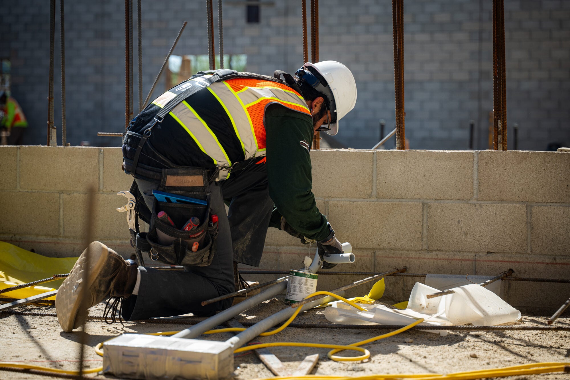 Electrician in full personal protective equipment during rough in