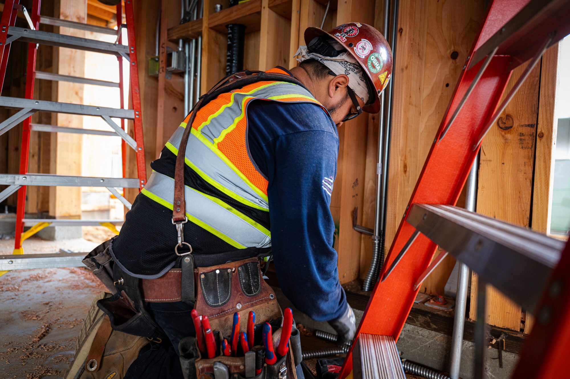 Electrician measuring a conduit run before cutting