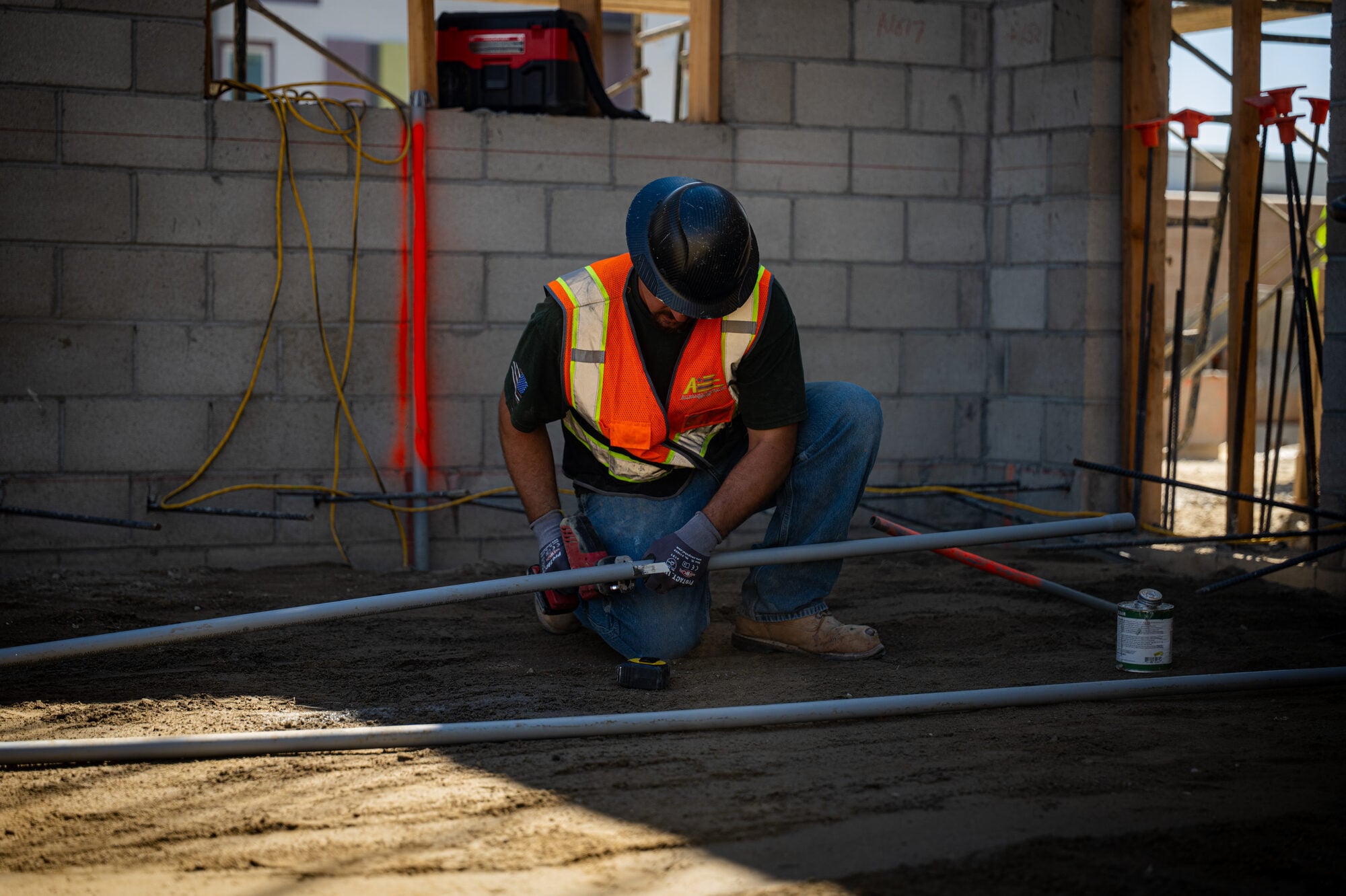 Electrician installing a supported conduit pipe run