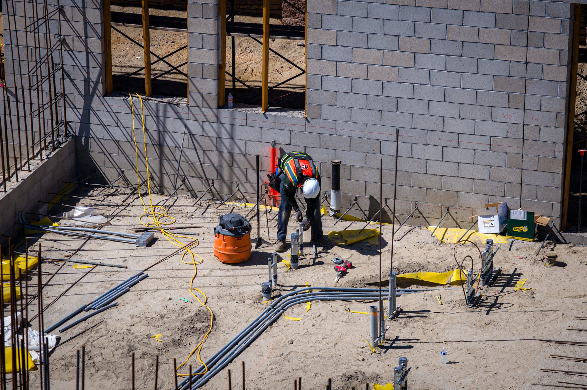 Conduit laid out across a slab ahead of the pour
