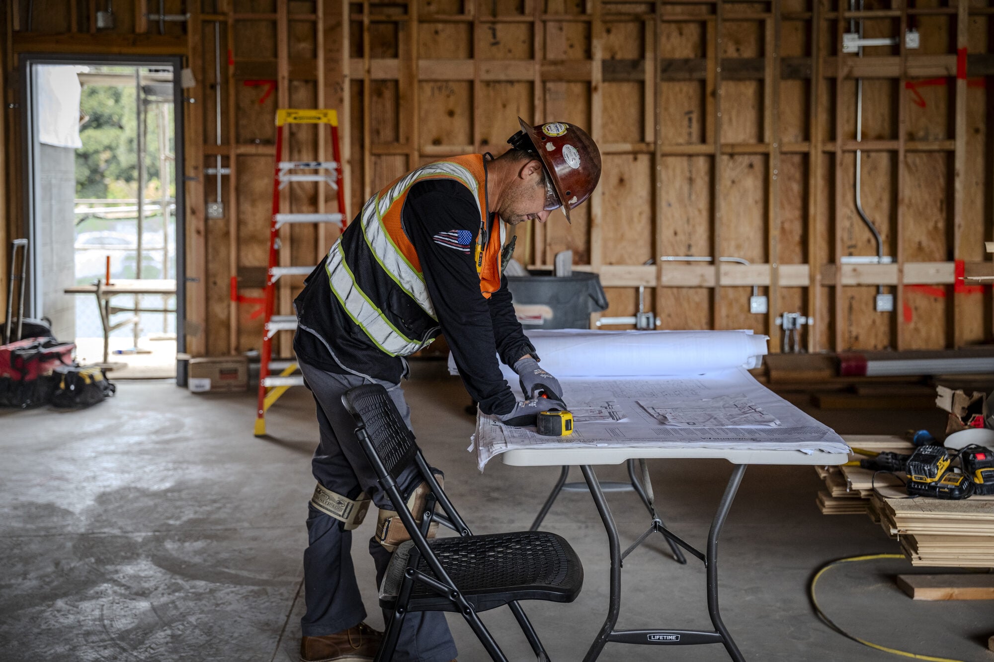 Electrician checking the drawings on site at Lakeside Middle School